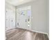 Bright foyer with wood-look floors, a white front door with glass, and white trim at 644 Ridge Gate Dr, Brownsburg, IN 46112
