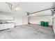 Spacious garage with painted floor, white storage cabinets, and a garage door at 644 Ridge Gate Dr, Brownsburg, IN 46112