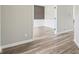 Hallway featuring wood-look floors leading to rooms with white trim and neutral walls at 644 Ridge Gate Dr, Brownsburg, IN 46112