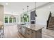 Kitchen featuring granite island, stainless steel appliances, and view of backyard pool through large windows at 644 Ridge Gate Dr, Brownsburg, IN 46112