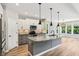 Modern kitchen with granite countertops, a stylish island, pendant lighting, and stainless appliances at 644 Ridge Gate Dr, Brownsburg, IN 46112