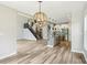 Spacious open-concept living room with hardwood floors, view of staircase, and granite island kitchen at 644 Ridge Gate Dr, Brownsburg, IN 46112