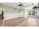 Bright living room with wood-look flooring features a ceiling fan, recessed lighting, and neutral paint colors at 644 Ridge Gate Dr, Brownsburg, IN 46112