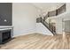 Bright living room with fireplace, tall ceilings, hardwood floors, and a staircase to the upper level at 644 Ridge Gate Dr, Brownsburg, IN 46112