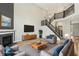 Bright and airy living room with a fireplace and staircase at 644 Ridge Gate Dr, Brownsburg, IN 46112