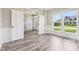 Living room with wood floors, white trim, white doors and large windows overlooking the yard at 644 Ridge Gate Dr, Brownsburg, IN 46112