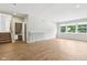 Bright living room with wood floors, a staircase and closet, plus a large window overlooking the outdoors at 644 Ridge Gate Dr, Brownsburg, IN 46112