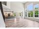 Open-concept living space with view of kitchen, dining area, and large windows overlooking backyard at 644 Ridge Gate Dr, Brownsburg, IN 46112