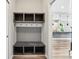 Functional mudroom with storage and bench seating leading into the modern kitchen at 644 Ridge Gate Dr, Brownsburg, IN 46112