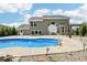 Backyard pool with basketball hoop and fountain features, surrounded by patio and lush landscaping at 644 Ridge Gate Dr, Brownsburg, IN 46112
