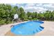 Backyard pool featuring concrete surrounding and a basketball hoop, perfect for recreation and relaxation at 644 Ridge Gate Dr, Brownsburg, IN 46112