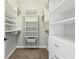 Well-organized walk-in closet with white shelving, drawers, and carpet at 644 Ridge Gate Dr, Brownsburg, IN 46112