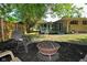 Backyard patio featuring outdoor seating, a grill, and a firepit, perfect for outdoor entertainment at 6550 Sunset Ln, Indianapolis, IN 46260