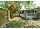 Backyard deck area features a well-maintained lawn, privacy fence, and mature landscaping at 6550 Sunset Ln, Indianapolis, IN 46260