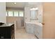 Corner sink and shower in an updated bathroom with custom shelving at 6550 Sunset Ln, Indianapolis, IN 46260