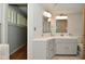 Corner sink with tiled floor and lighting fixtures in updated bathroom at 6550 Sunset Ln, Indianapolis, IN 46260