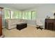 Inviting bedroom features multiple windows, a comfortable sofa, and a cozy chair at 6550 Sunset Ln, Indianapolis, IN 46260