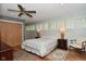 Comfortable bedroom with hardwood floors, ceiling fan, and bright natural light at 6550 Sunset Ln, Indianapolis, IN 46260