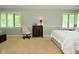 Bright bedroom with light gray walls, two windows, and comfortable furnishings at 6550 Sunset Ln, Indianapolis, IN 46260