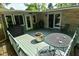 Backyard deck features dining table and chairs, providing the perfect spot for outdoor dining at 6550 Sunset Ln, Indianapolis, IN 46260