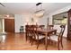 Elegant dining room boasts wood floors, seating for six, and is connected to the nearby kitchen at 6550 Sunset Ln, Indianapolis, IN 46260