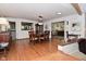 This spacious dining room features hardwood floors, a chandelier, and a view into the connected living spaces at 6550 Sunset Ln, Indianapolis, IN 46260