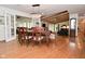 Bright dining room features hardwood floors, a wood table with seating for six, and an elegant chandelier at 6550 Sunset Ln, Indianapolis, IN 46260