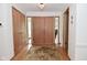 Inviting foyer with beautiful hardwood floors, chandelier, and large coat closet at 6550 Sunset Ln, Indianapolis, IN 46260
