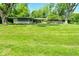 Single story ranch home featuring mature trees and a well manicured lawn at 6550 Sunset Ln, Indianapolis, IN 46260