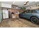Spacious garage with ample storage, a modern vehicle, and well-organized shelving at 6550 Sunset Ln, Indianapolis, IN 46260