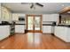 This kitchen features white cabinets, stainless steel appliances, and a view to the back deck at 6550 Sunset Ln, Indianapolis, IN 46260