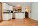 Bright kitchen with white cabinets, stainless steel appliances and a view into the nearby dining room at 6550 Sunset Ln, Indianapolis, IN 46260