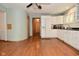 This kitchen features white cabinets, stainless steel appliances, and hardwood floors at 6550 Sunset Ln, Indianapolis, IN 46260