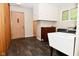 Functional laundry room with ample storage space, large sink, and convenient access to the exterior at 6550 Sunset Ln, Indianapolis, IN 46260