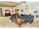 Inviting living room with a piano, exposed beams, and cozy furniture arrangement at 6550 Sunset Ln, Indianapolis, IN 46260