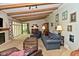 Bright living room with a fireplace, exposed beam ceiling, and comfortable seating area at 6550 Sunset Ln, Indianapolis, IN 46260
