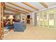Spacious living room featuring a fireplace, large windows, and exposed wood beam ceiling at 6550 Sunset Ln, Indianapolis, IN 46260