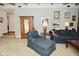 Comfortable living room with an accent chair, antique wardrobe, and lots of wall art at 6550 Sunset Ln, Indianapolis, IN 46260
