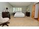 Serene bedroom featuring soft lighting, neutral color scheme, and plush bedding at 6550 Sunset Ln, Indianapolis, IN 46260