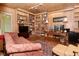Cozy office space featuring wood paneled walls and built-in bookshelves at 6550 Sunset Ln, Indianapolis, IN 46260