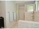 Bathroom featuring a shower stall with glass door and tiled walls at 6550 Sunset Ln, Indianapolis, IN 46260