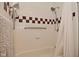 Bathroom shower area with checkered tiles, grab bar, and shower curtain at 6550 Sunset Ln, Indianapolis, IN 46260