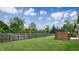 Well-maintained backyard with lush green grass and a privacy fence, providing a serene outdoor space at 8338 Hunters Meadow Way, Indianapolis, IN 46259