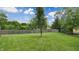 Picturesque backyard with a lush lawn, privacy fence, and mature trees, offering a peaceful retreat at 8338 Hunters Meadow Way, Indianapolis, IN 46259