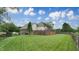 Expansive backyard featuring well-manicured lawn, mature trees, and a partial privacy fence, ideal for recreation at 8338 Hunters Meadow Way, Indianapolis, IN 46259