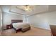 Serene main bedroom featuring tray ceilings, soft carpet, and a comfortable bed with side tables at 8338 Hunters Meadow Way, Indianapolis, IN 46259