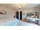 Sunlit bedroom features a desk with vanity, complemented by soft neutral walls and carpet at 8338 Hunters Meadow Way, Indianapolis, IN 46259