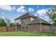Beautiful home exterior with a brick facade, well-manicured lawn, and privacy fence, showcasing curb appeal at 8338 Hunters Meadow Way, Indianapolis, IN 46259