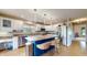 Updated kitchen with white cabinets, stainless steel appliances, and a blue island with wicker seating at 8338 Hunters Meadow Way, Indianapolis, IN 46259