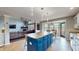 Bright kitchen features an island with blue cabinets, pendant lighting, and an adjacent breakfast nook at 8338 Hunters Meadow Way, Indianapolis, IN 46259